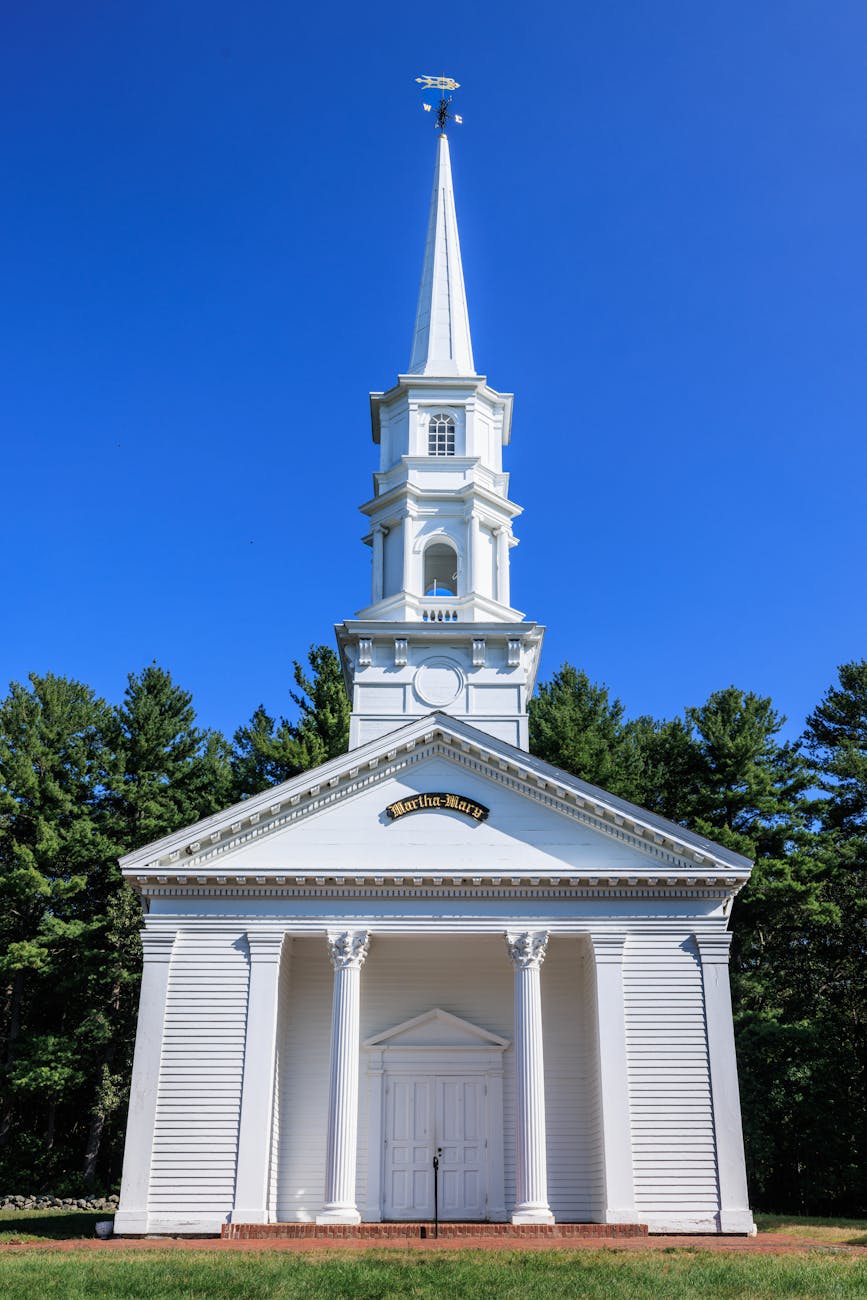historic white church in sudbury with blue sky